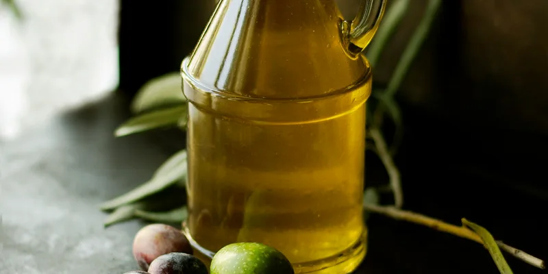 Artisan olive oil in a glass cruet, golden and luminous