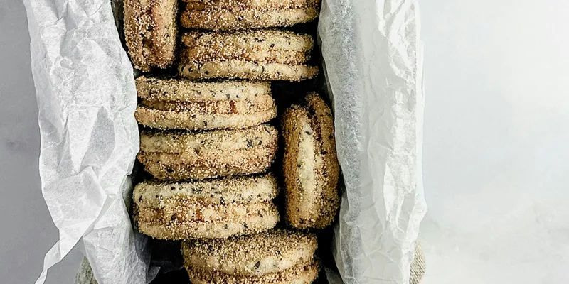 Golden shortbread cookies stacked in a rustic arrangement